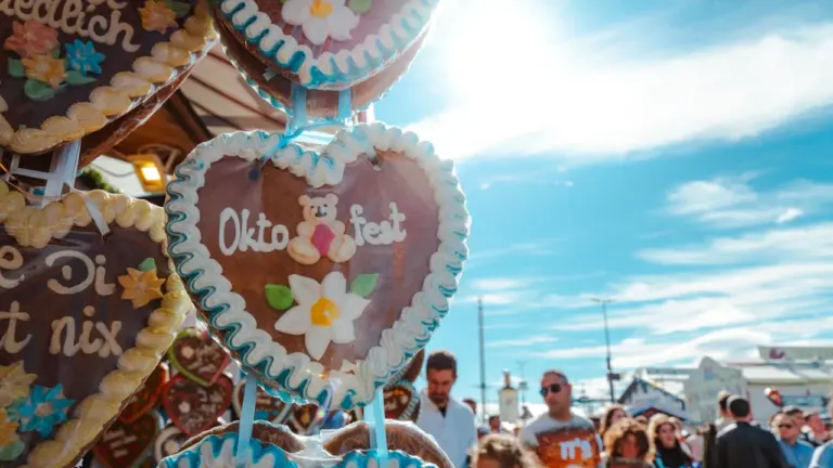 Traditionelle Lebkuchenherzen auf einem Volksfest in einer sonnigen deutschen Stadt bei Tag.